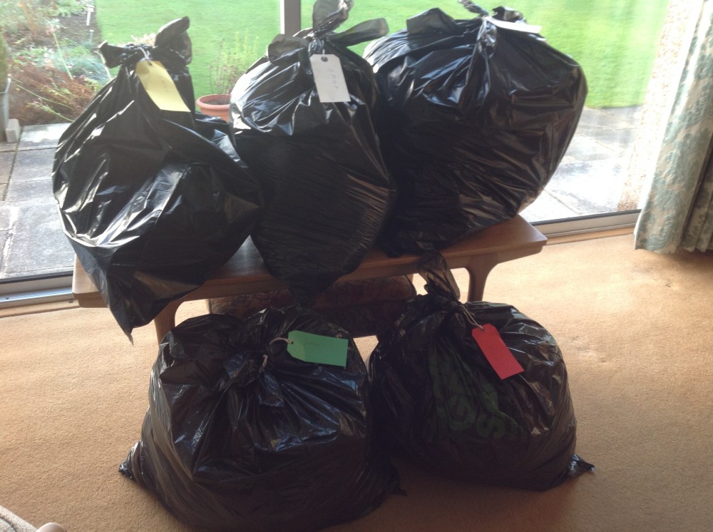 photograph of bin bags full of handknitting ready for distribution to charity